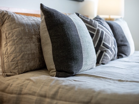 Sink into your plush, carefully made bed with soft linens and thoughtfully arranged pillows—everything's ready for you to unwind and enjoy a truly restful night.