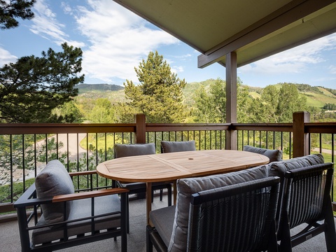 Sip your morning coffee on your private balcony, where rolling green hills and mountain vistas frame every peaceful moment. This covered terrace offers the perfect spot to unwind and soak in nature.