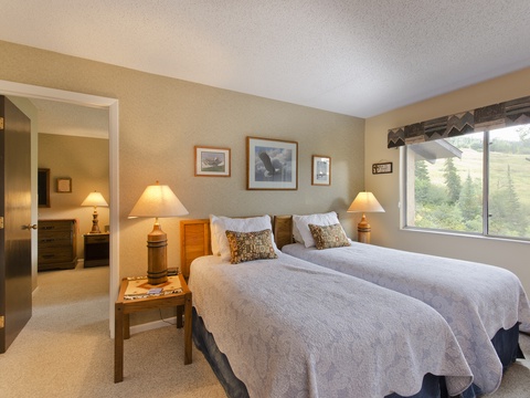 Relax in comfort with two plush beds dressed in soft linens. Morning light streams through your window, framing stunning mountain views that greet you each day.