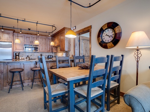 Picture your group gathered around this inviting dining table, sharing stories and meals in a space that blends rustic charm with modern comfort, all connected to your fully equipped kitchen.