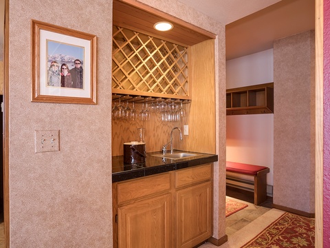 Your own wet bar with wine storage, glassware, and sink makes entertaining effortless, while the charming lattice wine rack adds rustic elegance to your space.