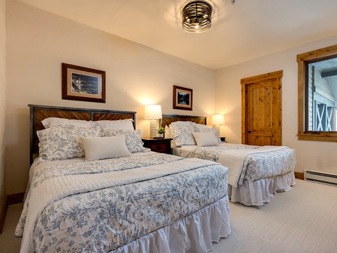 Unwind in your serene retreat with two plush beds dressed in soft linens, warm wood accents, and gentle lighting that invites restful nights.