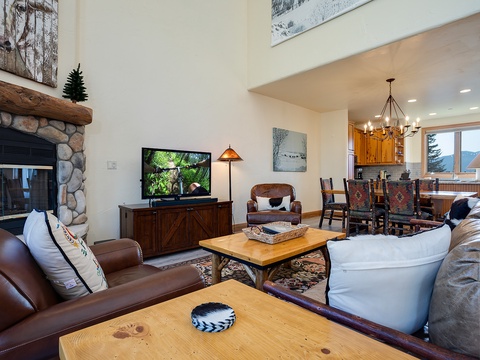 Settle in by the fire or gather around for movie night—this inviting living area flows into your dining space, making it the heart of your mountain retreat.