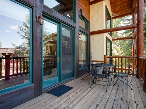 Step onto your private balcony, where warm wood tones meet mountain fresh air. Enjoy morning coffee at your intimate bistro table surrounded by towering pines and peaceful forest views.