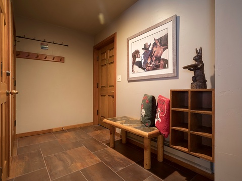 Step inside to a warm, welcoming entryway with rustic charm—your home away from home with thoughtful storage, cozy decor, and artistic touches that set the tone for your stay.