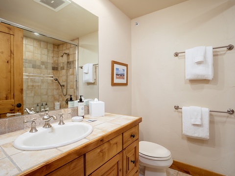 Freshen up in your well-appointed bathroom with a tiled shower, plush towels, and thoughtful amenities to make you feel right at home.