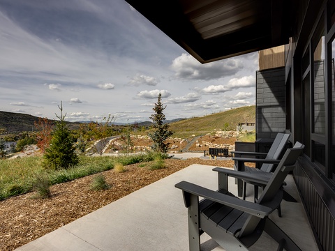 Step outside to your private covered patio and take in sweeping mountain views. Two Adirondack chairs invite you to unwind beneath the open sky, surrounded by peaceful natural beauty and fresh air.