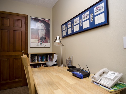 Your personal workspace awaits with a solid wood desk, task lighting, and phone—perfect for staying connected or catching up on work during your stay.