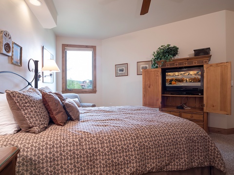Sink into the plush bed and enjoy soft linens, warm lighting, and charming décor. Your mountain getaway awaits beyond the window, while your entertainment center keeps you cozy inside.