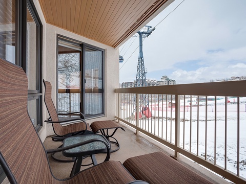 Your private balcony offers a cozy spot to unwind with lounge chairs and soothing views of the ski slopes and surrounding mountain scenery.