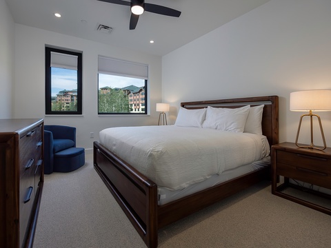 Sink into plush bedding and drift off to the gentle hum of the ceiling fan, while mountain views frame your restful retreat.