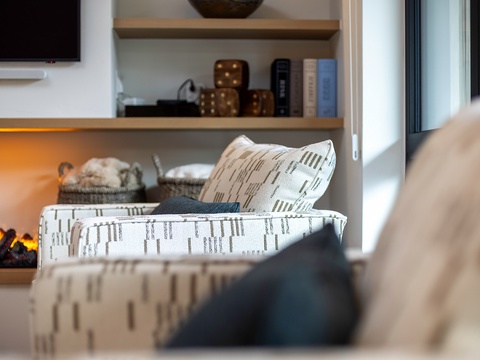 Sink into plush seating surrounded by warm textures and glowing ambient light—your cozy retreat awaits after a day of adventure.