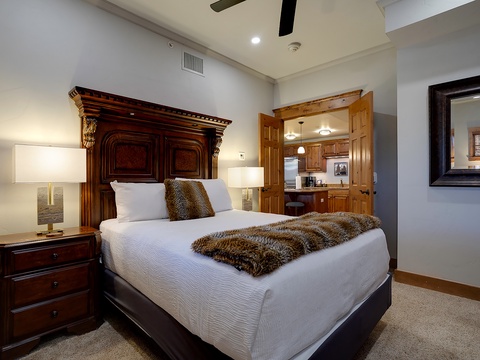 Slip into crisp linens and luxurious textures in your elegant bedroom, complete with a plush throw and easy access to the kitchen for late-night snacks or morning coffee.