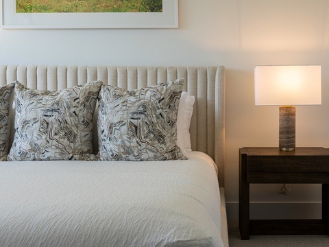 Sink into plush pillows and crisp linens in your elegantly appointed bedroom. A soft bedside lamp invites you to unwind after a day of exploring.