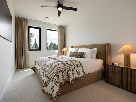 Sink into your plush bed and let the gentle ceiling fan keep you cool. Natural light pours through your windows, framing leafy views that set the tone for a restful retreat.