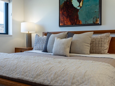 Slip into soft linens and sink into plush pillows – your peaceful retreat awaits with natural light streaming through the window, setting the perfect mood for relaxation.