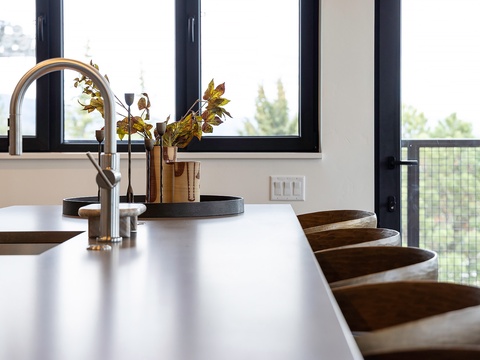Your gourmet kitchen features modern fixtures, natural light, and thoughtful design—a perfect space for preparing delicious meals during your stay while enjoying peaceful views of the surrounding greenery.