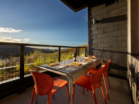Picture yourself dining al fresco as the sun sets, casting a warm glow over rolling hills and distant mountains. Your private balcony invites you to savor meals, sip wine, and soak in breathtaking views framed by wide-open skies.