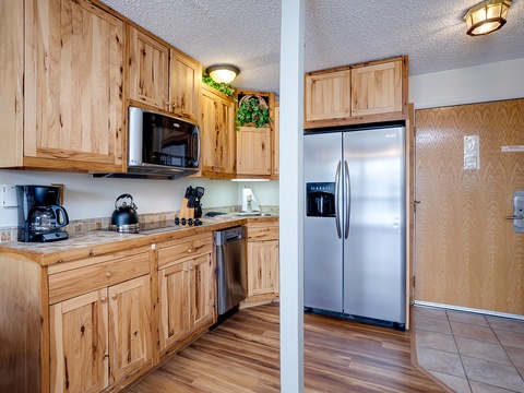 Your kitchen awaits with rich wooden cabinetry, stainless steel appliances, and everything you need to whip up a home-cooked meal or brew your morning coffee.
