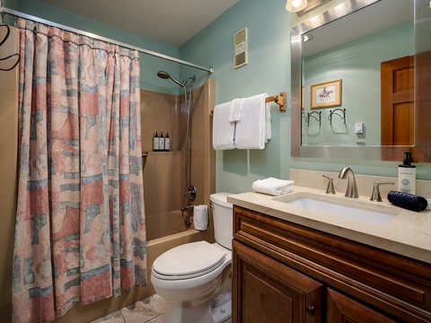 Refresh in your private bath with a tub-shower combo, soft towels, and thoughtfully chosen coastal-inspired touches that make this space feel both relaxing and inviting.