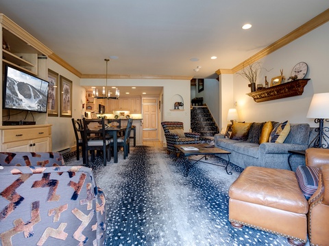 Step into your spacious studio where cozy mountain living meets modern comfort. Unwind on plush seating, gather around the dining table, or relax with your favorite show—all in one inviting open space.