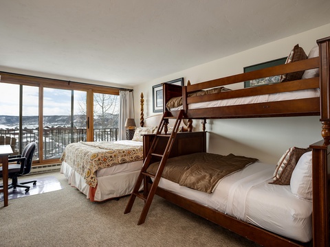 Wake up to stunning mountain views from your cozy bedroom, with comfortable sleeping arrangements for the whole family and a private balcony overlooking the scenic landscape.