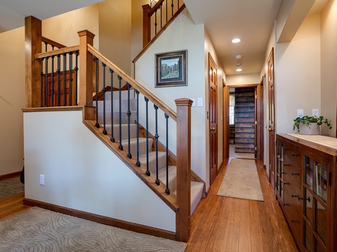 A welcoming entry hall greets you with warm wood tones, a stylish staircase, and thoughtful storage—your home base for mountain adventures ahead.