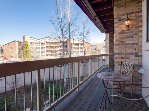 Step onto your private balcony and enjoy morning coffee at this cozy bistro table. The peaceful neighborhood setting offers tree-lined views and a serene spot to unwind after exploring the area.