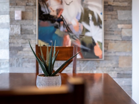Artful touches bring warmth to your living space with modern décor, vibrant wall art, and natural greenery creating a welcoming retreat.