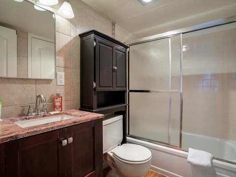 Freshen up in your private bathroom with its walk-in shower, granite countertop, and warm wood cabinetry. Everything you need is right here for a relaxing stay.