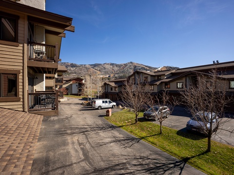 Mountain resort community featuring private balconies and parking, set against a scenic mountain backdrop in a peaceful residential setting.