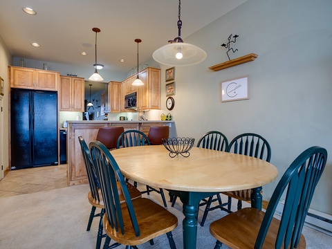 Gather around this spacious dining table where your group can share meals and make memories together. The open-concept layout connects seamlessly to a fully equipped kitchen, making meal prep and conversation easy.