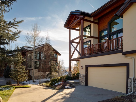 This mountain-style property features charming wood and stone details, a private balcony, and convenient garage parking, all set in a serene neighborhood with mature trees.