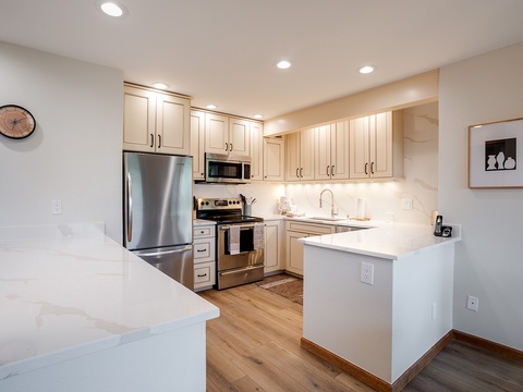 Your fully equipped kitchen features sleek stainless steel appliances, elegant marble countertops, and abundant cabinet space—perfect for preparing meals during your stay.