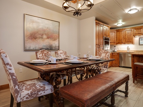 Gather around this elegant dining table where memorable meals and lively conversation await. The warm lighting and stylish décor create the perfect setting for your group dinners.