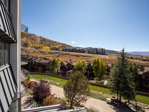 Mountain resort landscape with surrounding residential buildings and natural terrain in autumn, viewed from the property.