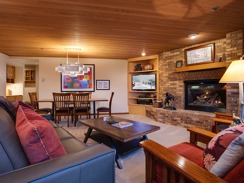Unwind in your spacious living area with a crackling fireplace, cozy seating, and warm wood accents creating the perfect retreat after a day of adventure.