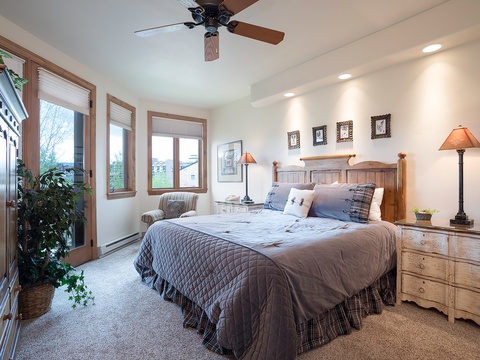 Your peaceful bedroom retreat features a plush king bed, warm wood furnishings, and soft lighting—perfect for unwinding after a day of adventure.