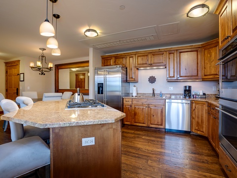 You'll love gathering in this fully equipped kitchen with granite counters, stainless appliances, and a spacious island perfect for meal prep or casual conversation.