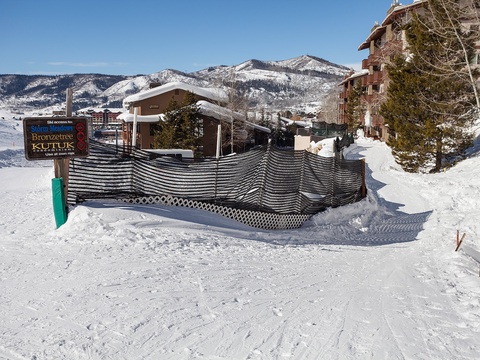 Ski resort entrance at the base of snow-covered mountains, with direct ski-in/ski-out access to the property and surrounding alpine village.