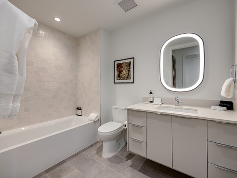 Your modern bathroom features a deep soaking tub, sleek vanity, and contemporary finishes that create a serene space to unwind after a day of adventure.