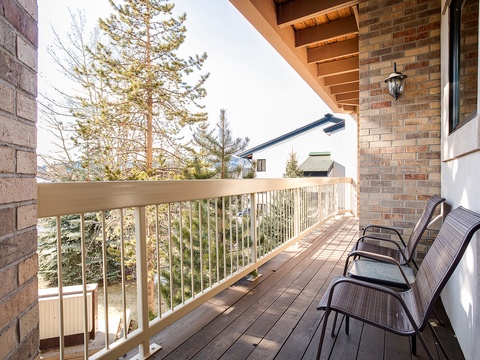 Settle into your private balcony where mountain air mingles with sunlight. Three chairs await for morning coffee or evening conversations framed by evergreen views.