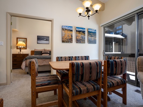 Gather for meals at your cozy dining table, perfectly positioned between the bedroom and private balcony for easy indoor-outdoor living.