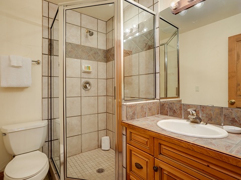 Refresh in your private bathroom with a spacious walk-in shower, tiled finishes, and fresh towels ready for your stay.