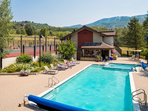 The property features a sparkling outdoor pool, tennis court, and mountain views set within beautifully landscaped grounds ideal for relaxing getaways.