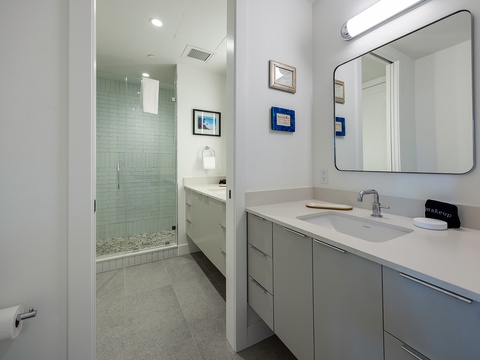 Your private sanctuary awaits with sleek countertops, plenty of storage, and a spacious walk-in shower where you can wash away the day in complete comfort.