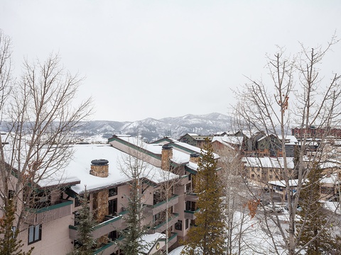 A mountain resort set against snow-covered peaks, offering a peaceful winter retreat surrounded by alpine landscapes and seasonal tranquility.