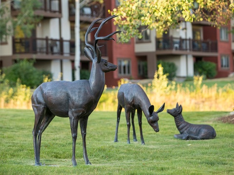 Striking sculptures grace the property's landscaped grounds, showcasing artistic details and creating a unique character in the surrounding neighborhood.