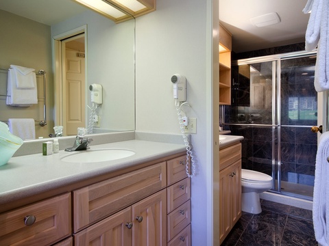 Freshen up in your spa-inspired bathroom, featuring dual vanities, plush towels, and a luxurious walk-in shower—your personal retreat after a day of adventure.