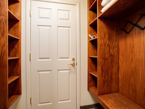 Unpack and settle in with ease. Your private entryway features built-in wooden shelving and hanging space, making organization effortless from the moment you arrive.